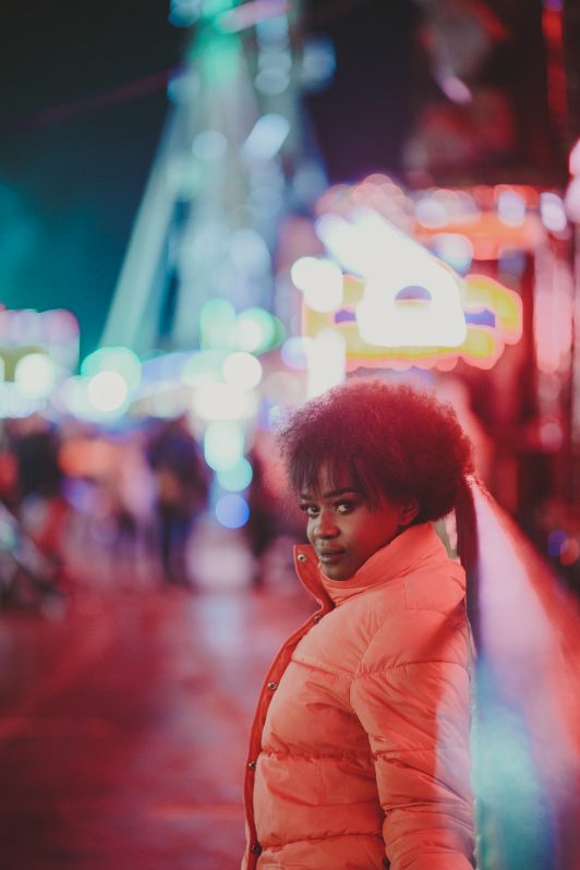 Model in peach puffer looking over the shoulder